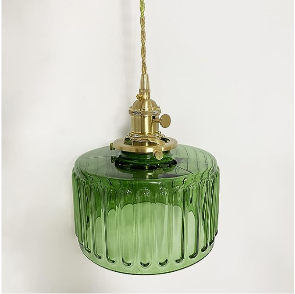 Green glass pendant light with brass fitting on a white background