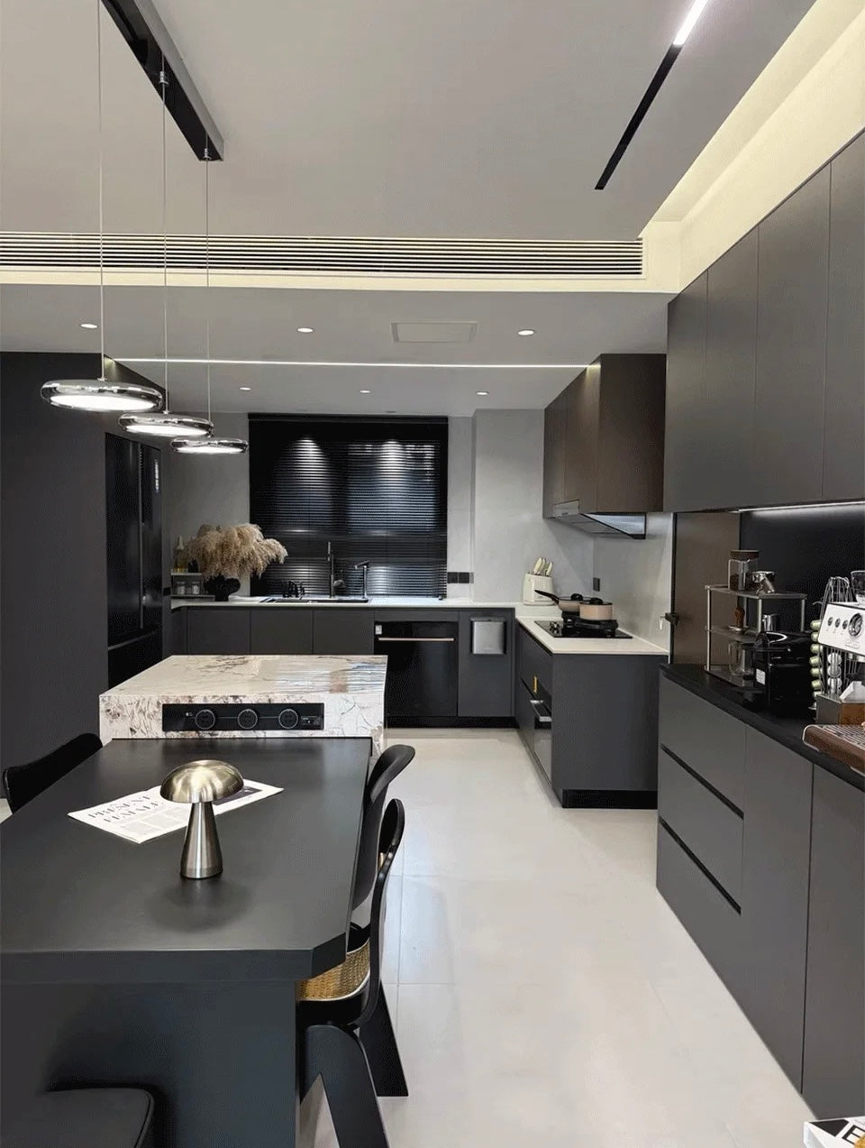 Modern kitchen with black cabinetry and marble island