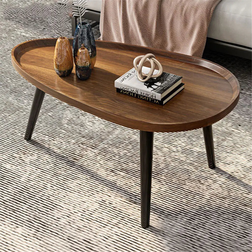 Wooden coffee table with decorative items on a textured floor