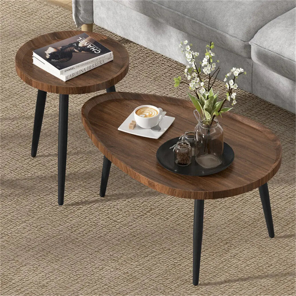 Wooden coffee table with a cup of coffee and flowers on a carpeted floor.