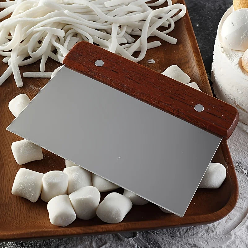 Wooden spatula on a tray with noodles and marshmallows