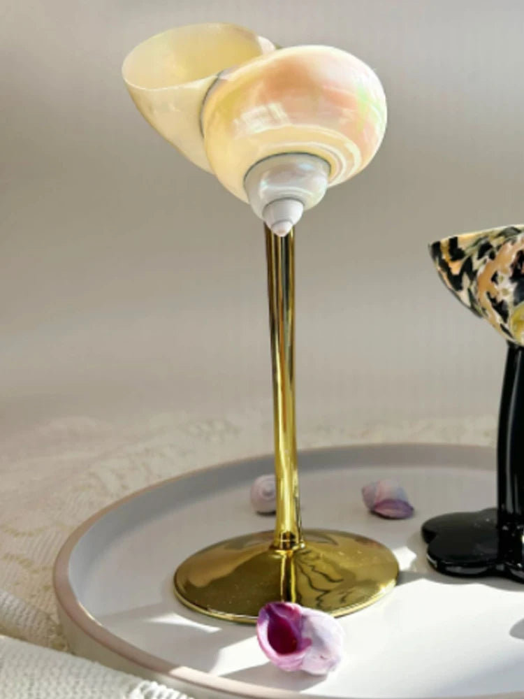 Decorative lamp with shell design on a white surface