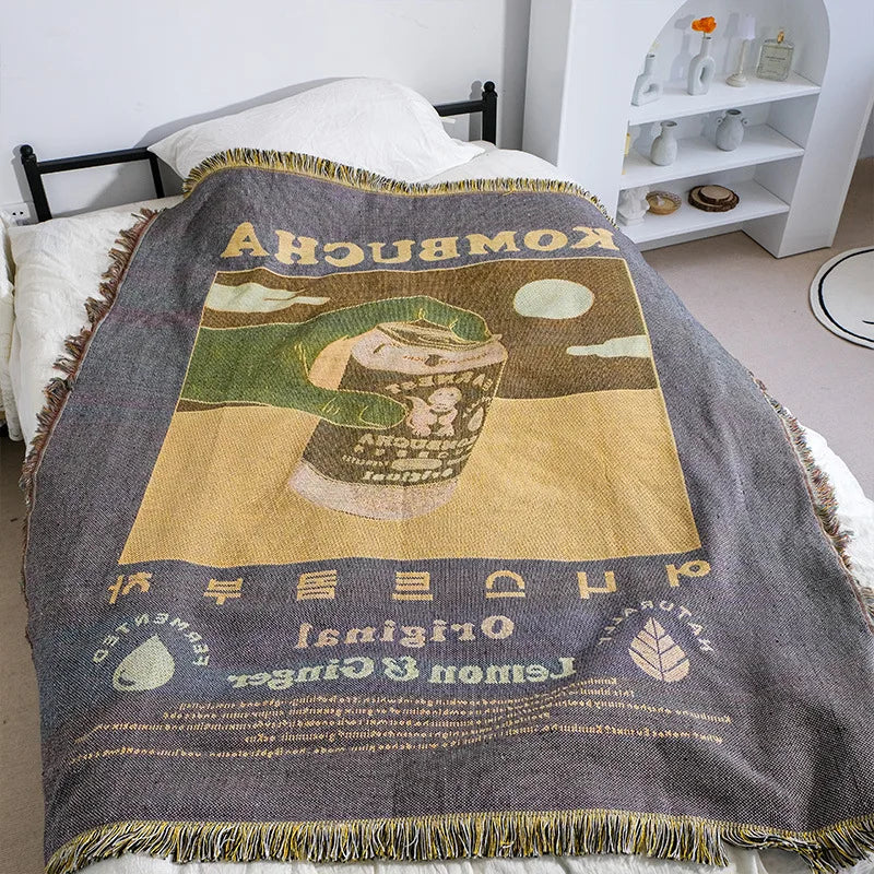 Textile with kombucha design draped over a bed in a room.