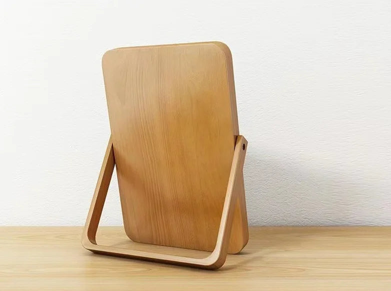 Back of a wooden mirror on a wooden surface with a white background