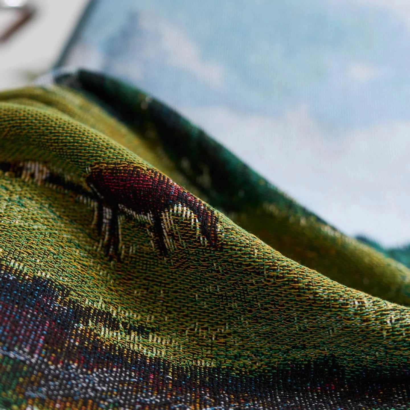 Close-up of a textured fabric with embroidered design on a garment.