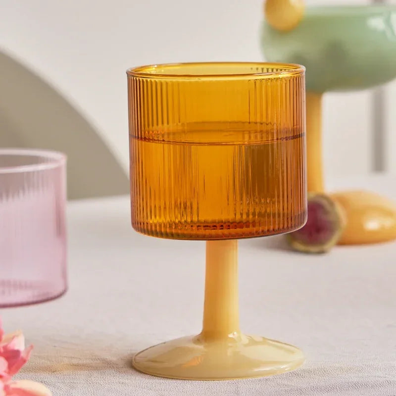 Amber glass with ribbed design on a white surface