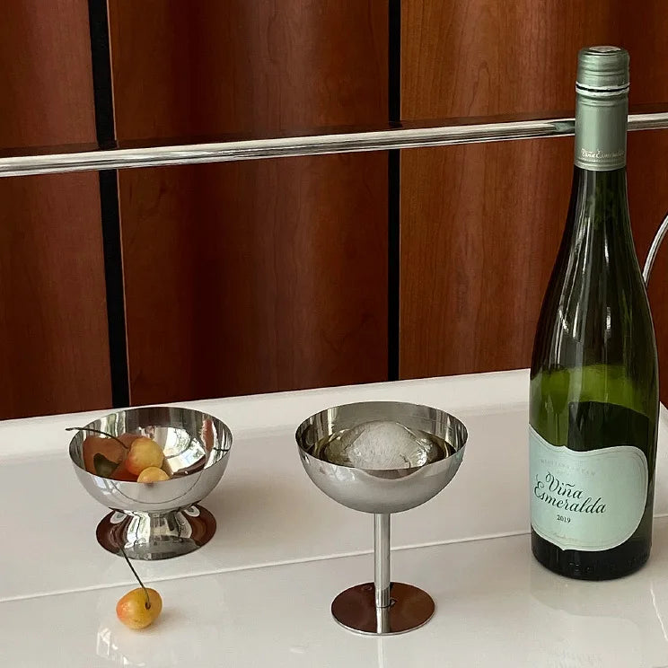 Bottle of Vina Esmeralda wine with two metal bowls on a white surface.