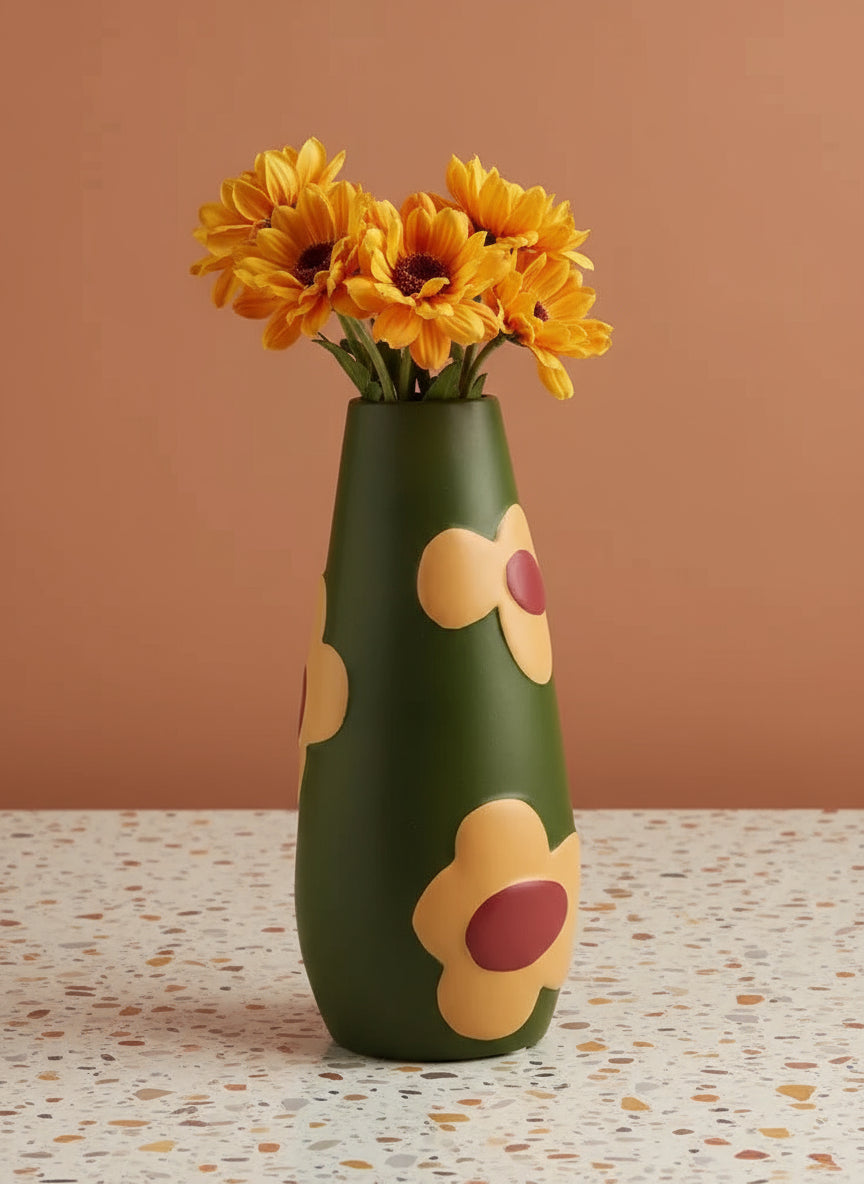 Green vase with floral designs on a beige background