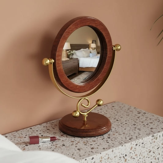 Round wooden mirror on a stand with a gold frame, placed on a wooden surface.