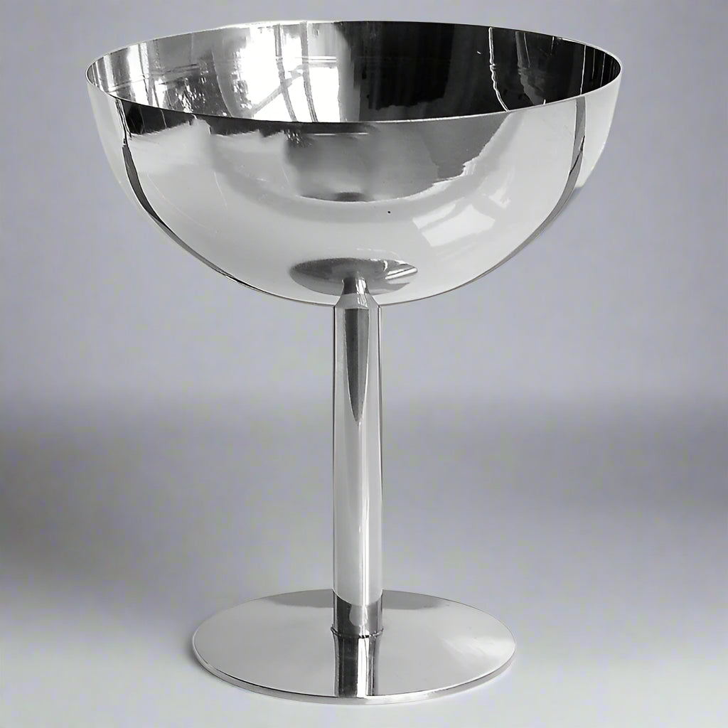 Silver bowl on a stand against a white background