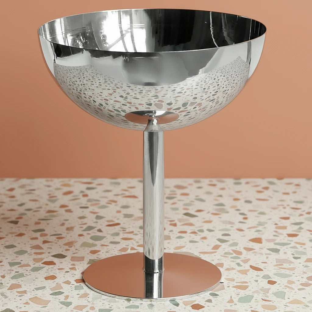 Silver bowl on a stand against a white background
