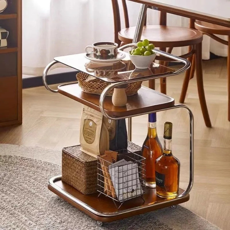 Wooden serving cart with food and drinks in a home setting