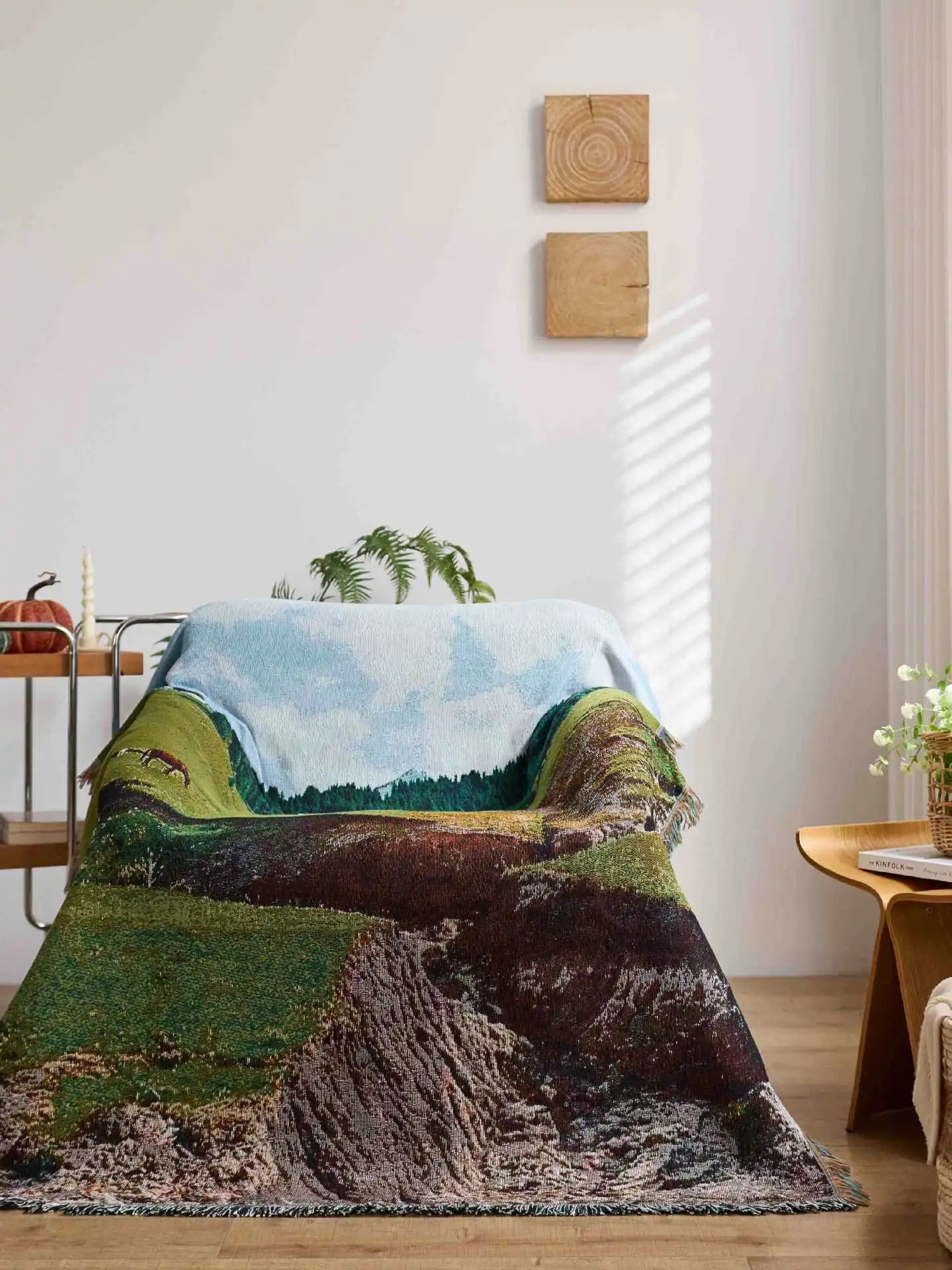 Nature-themed blanket draped over a bed in a room with wooden furniture and decor.