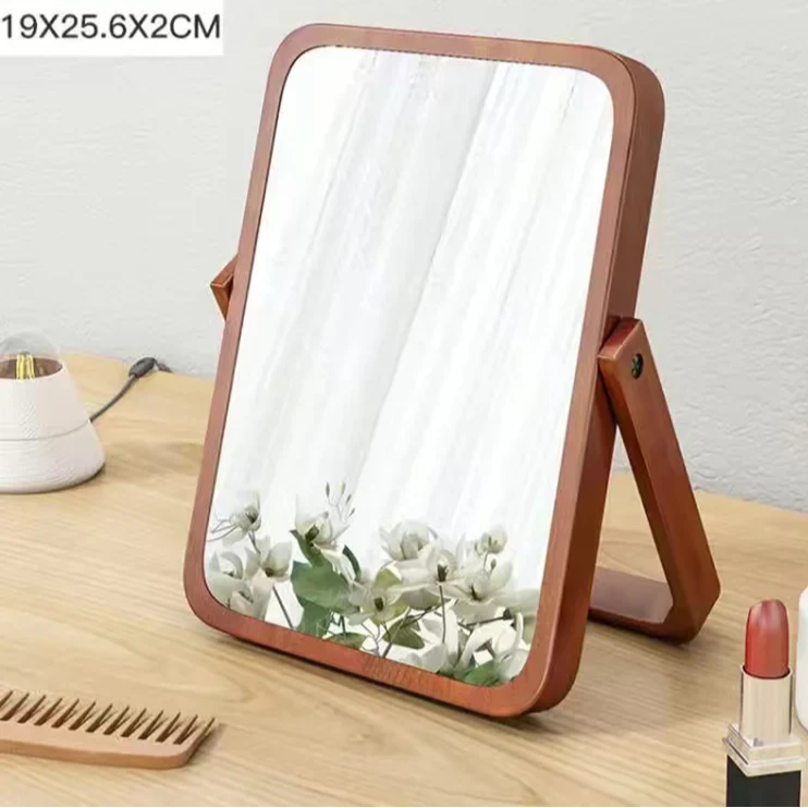 Brown rectangular mirror on a wooden surface with a white background