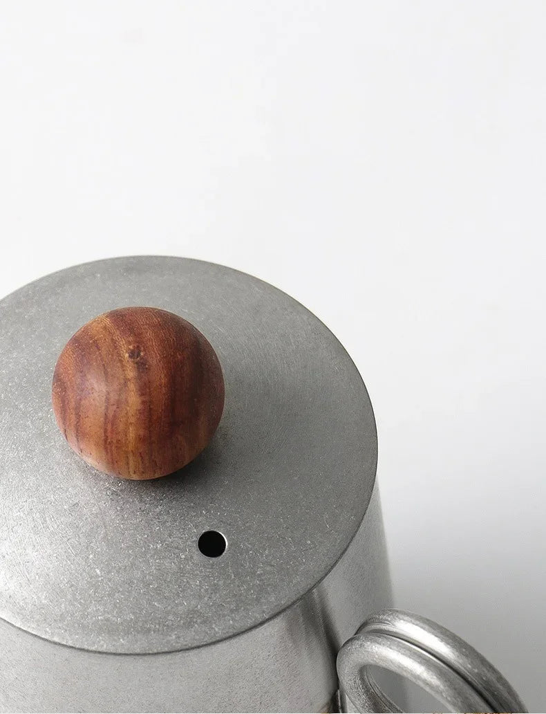 Wooden ball on a metal lid with a white background