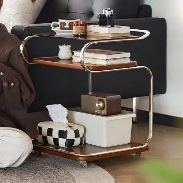 Woman reading a book on a gray sofa with a coffee table in front of her