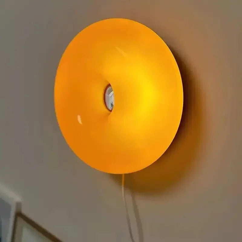 Orange wall light fixture on a neutral wall