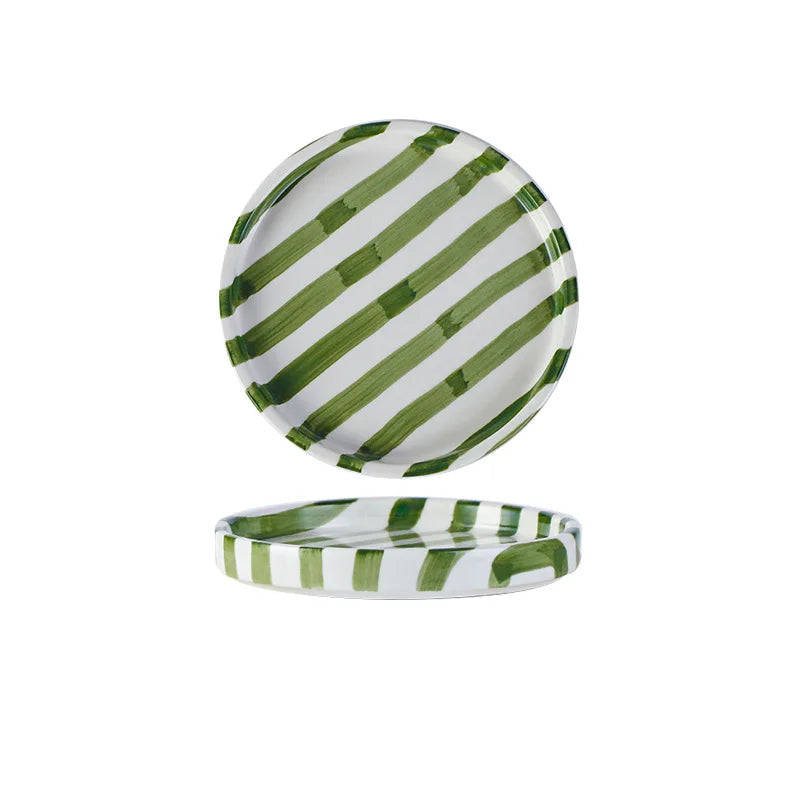 Green and white striped ceramic plate with measurements on a white background