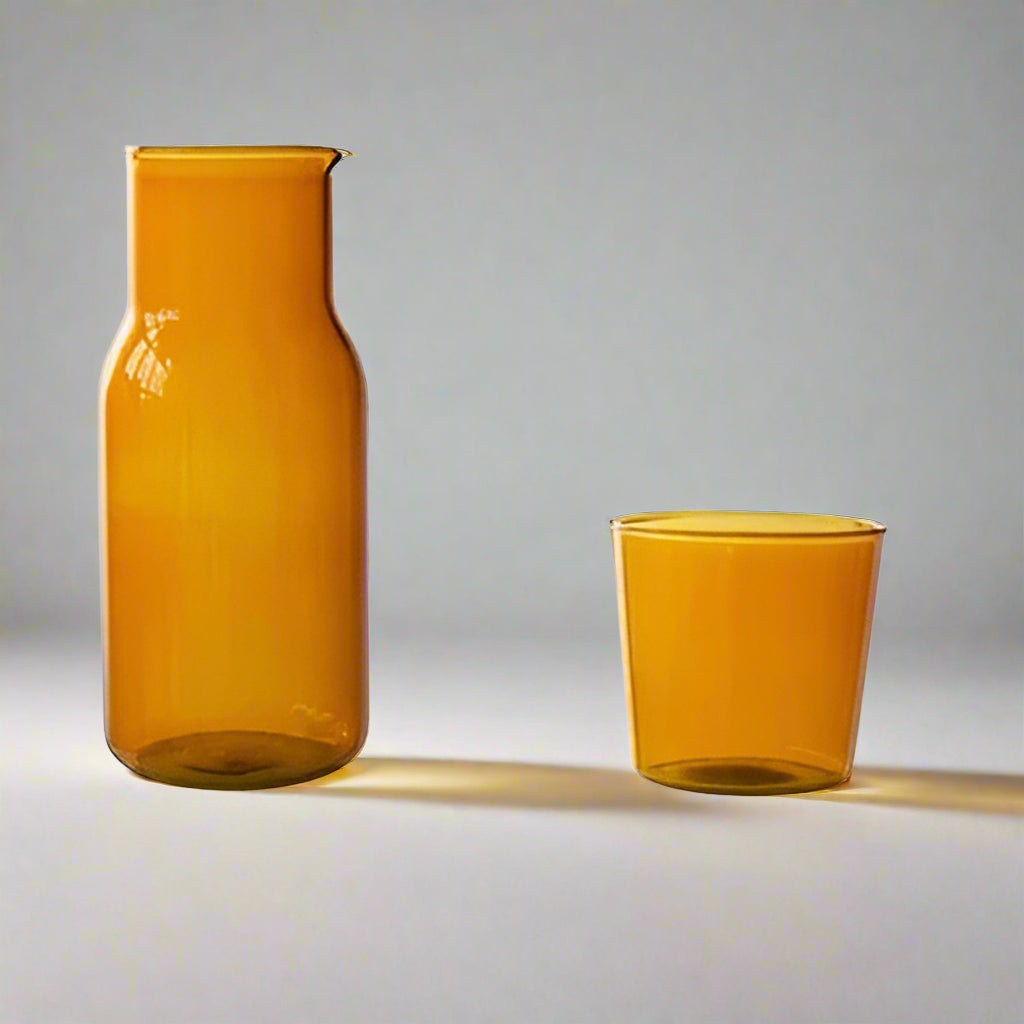 Two amber-colored glass containers with measurements on a white background