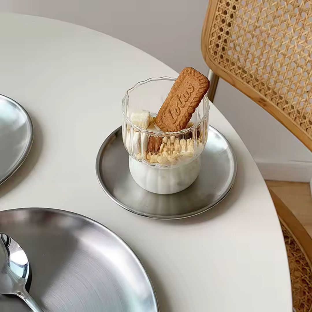 Glass dessert with a cookie on a white table