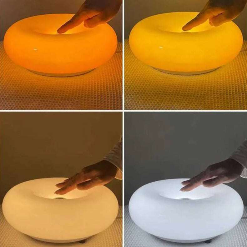 Collage of a glowing ring-like object with a hand interacting with it, shown in four different colors.