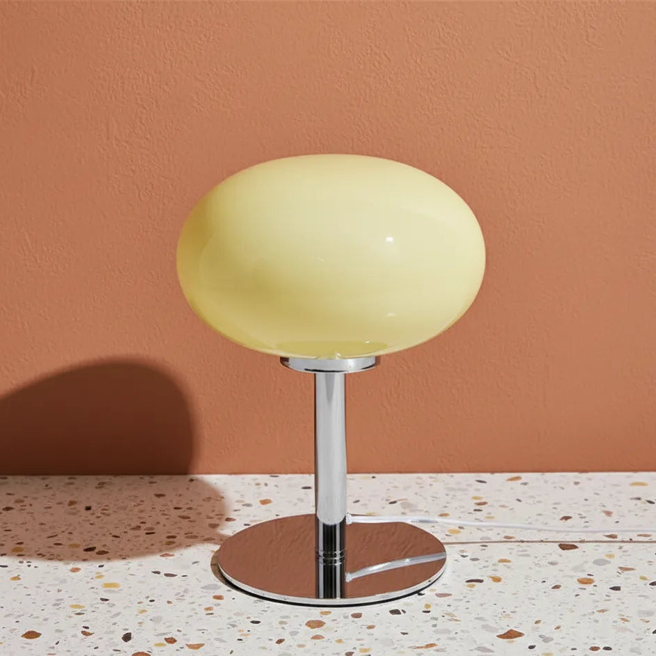 Yellow table lamp on a terrazzo floor with a brown wall background