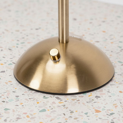 Close up of a light switch on a gold stemmed table lamp.