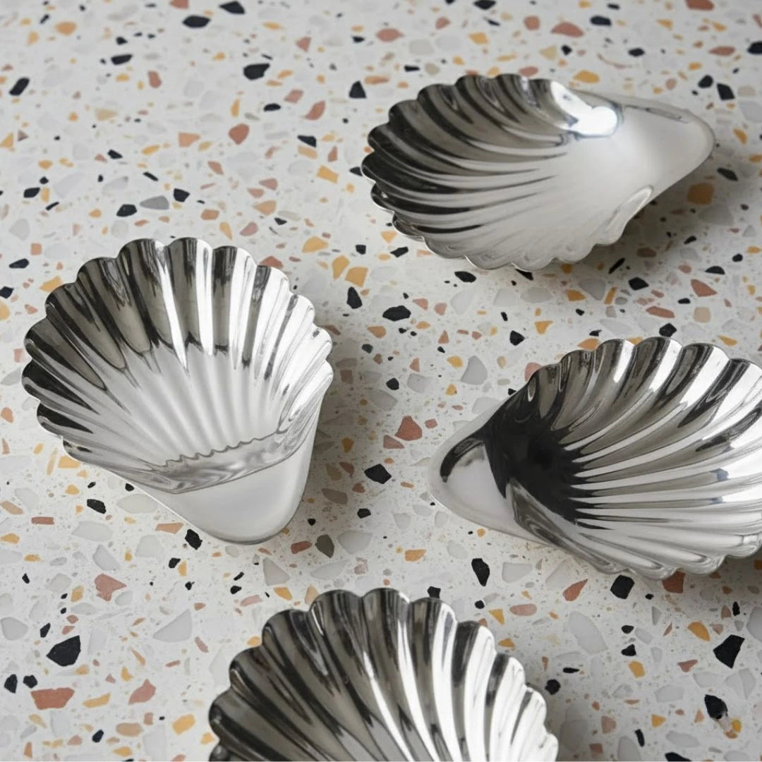 Silver shell-shaped cups on a terrazzo countertop
