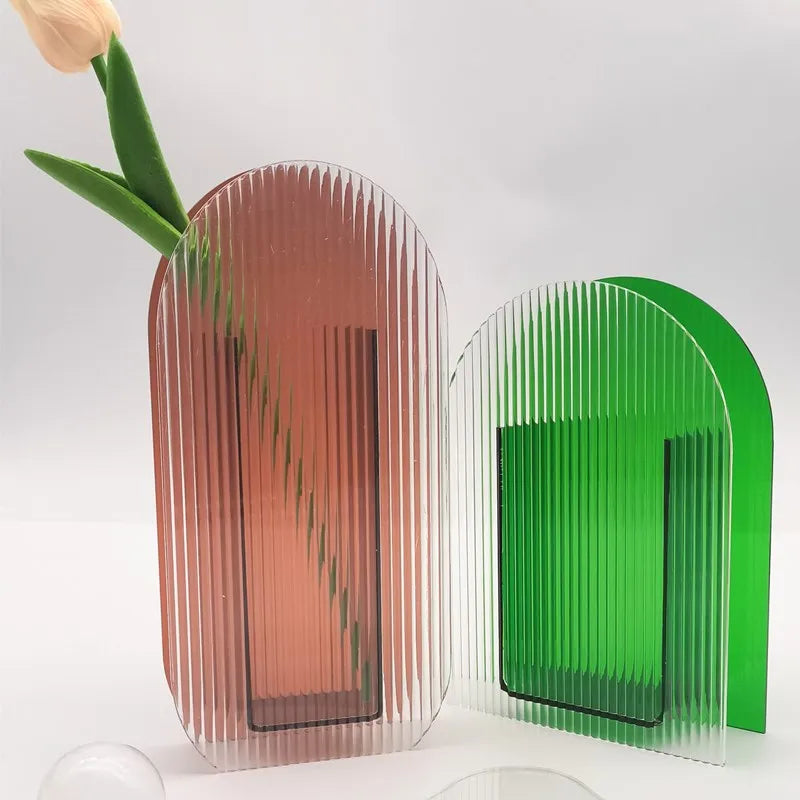 A brown and a green vase on white backdrop 