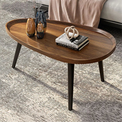 Wooden coffee table with decorative items on a textured floor