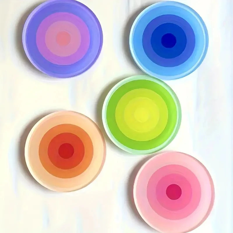 Five colorful circular objects with concentric patterns on a white background