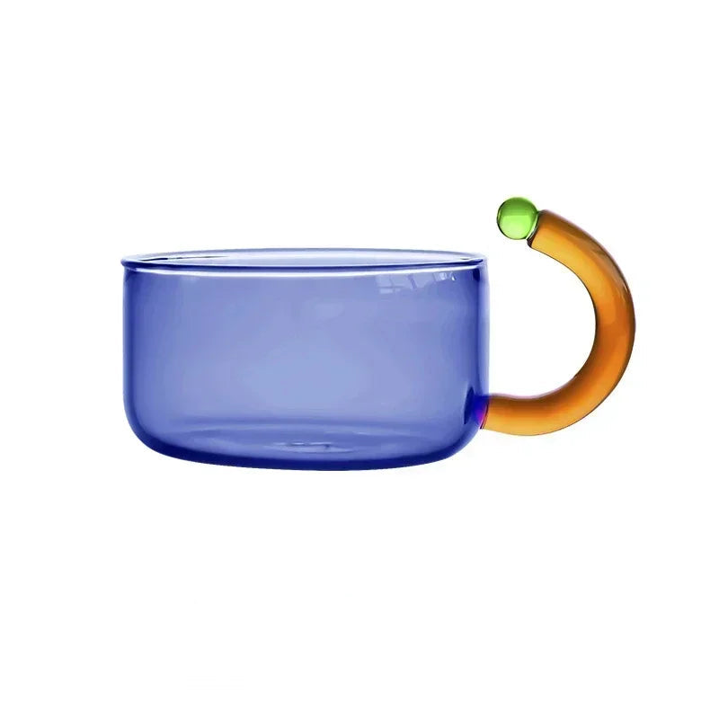 Blue glass mug with an orange handle on a white background