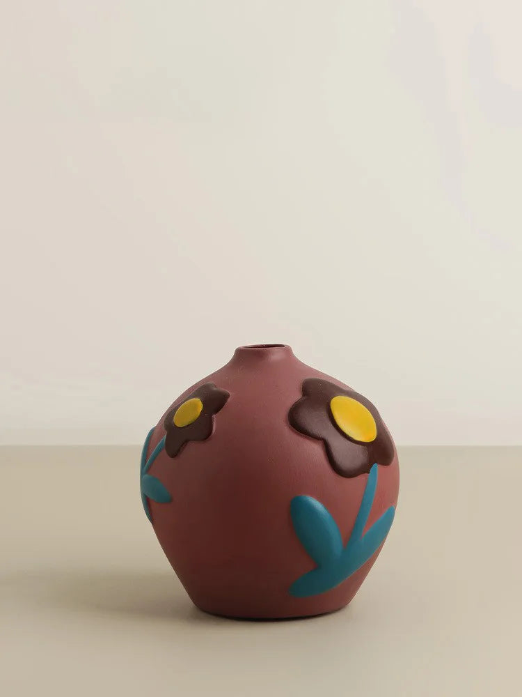 Decorative vase with floral designs on a beige background