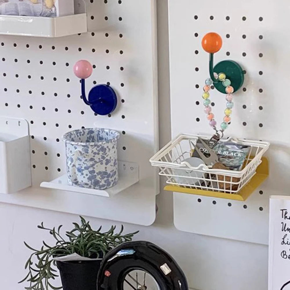 Pegboard wall with shelves, hooks, and decorative items
