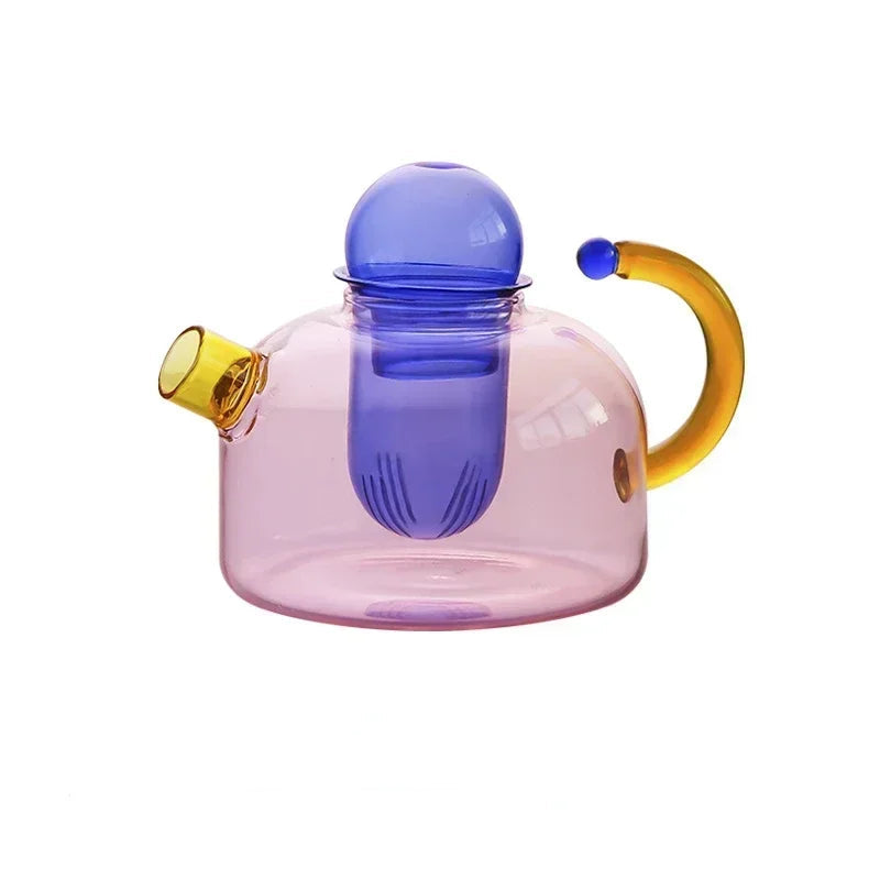 Colorful glass teapot with a blue spout and yellow handle on a white background