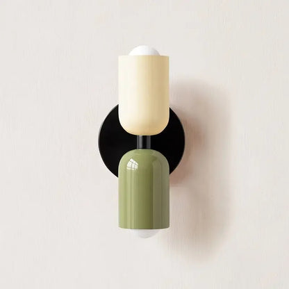 Wall-mounted light fixture with a black, beige, and green design on a white background