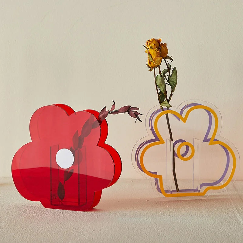 Red and clear flower vases on white backdrop