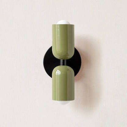 Wall-mounted light fixture with green and black design on a white background