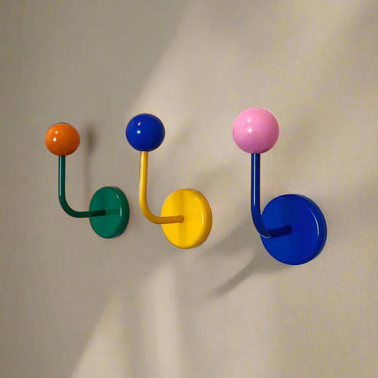 Four colorful wall hooks on a white background
