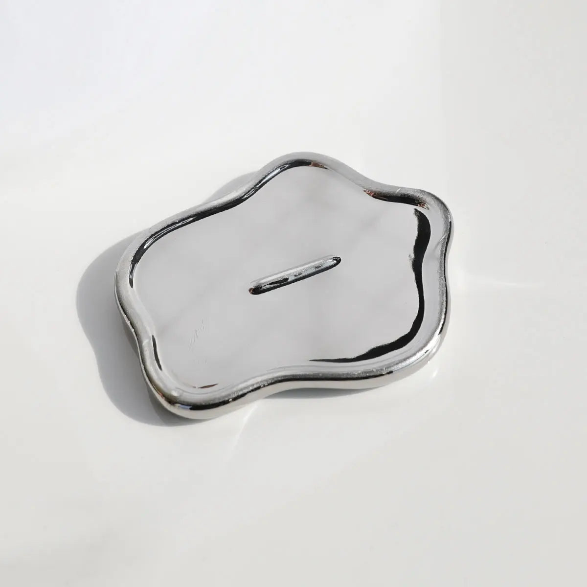Silver decorative object on a white background