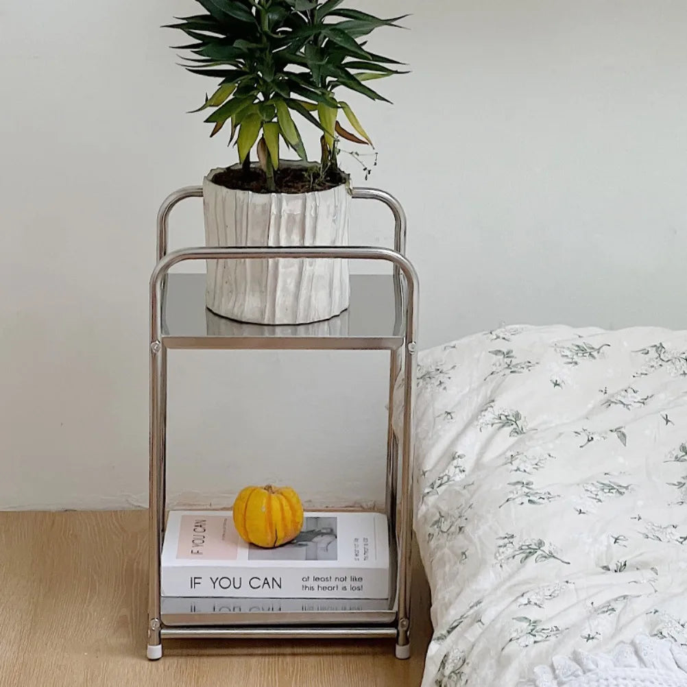 Metal cart with plant pot next to a floor bed