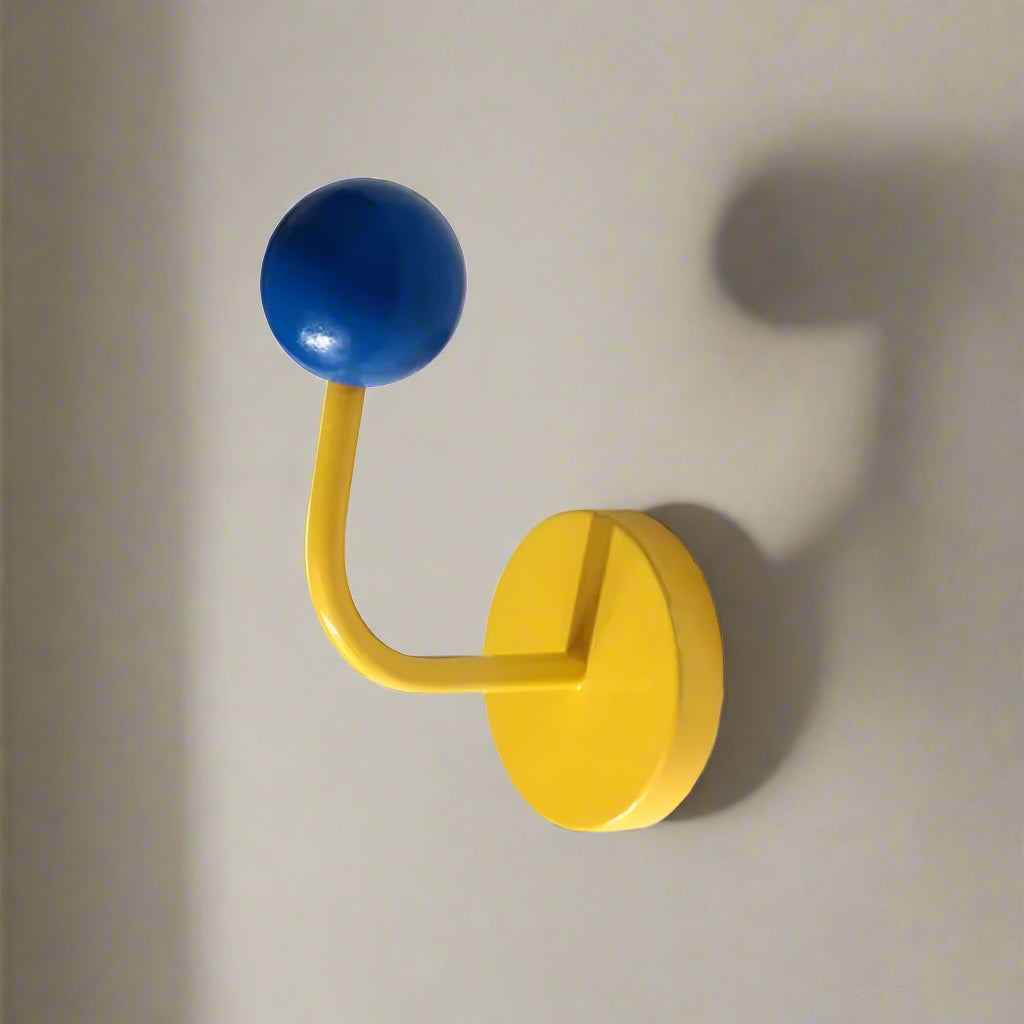 Yellow hook with a blue ball on a white background
