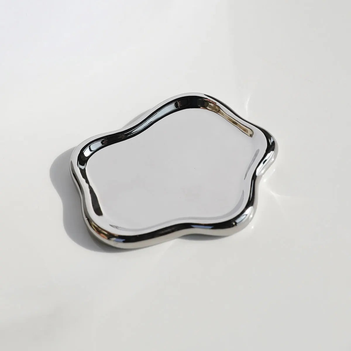 Silver decorative tray on a white background