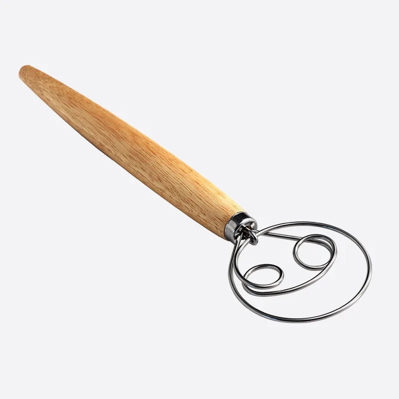 Wooden handle with metal dough whisk on a white background