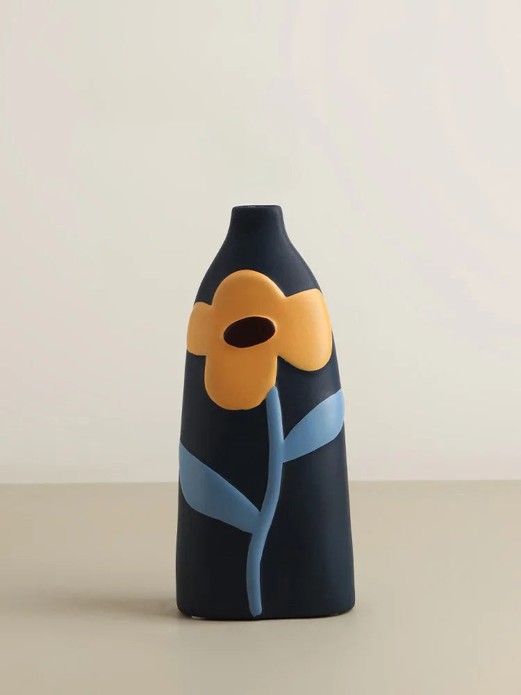 Decorative vase with a yellow flower and blue stem on a beige background