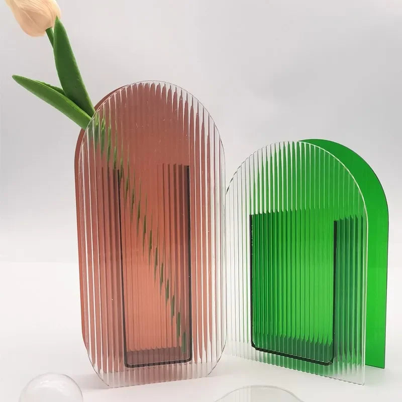 Brown vase and a green vase on a white backdrop 