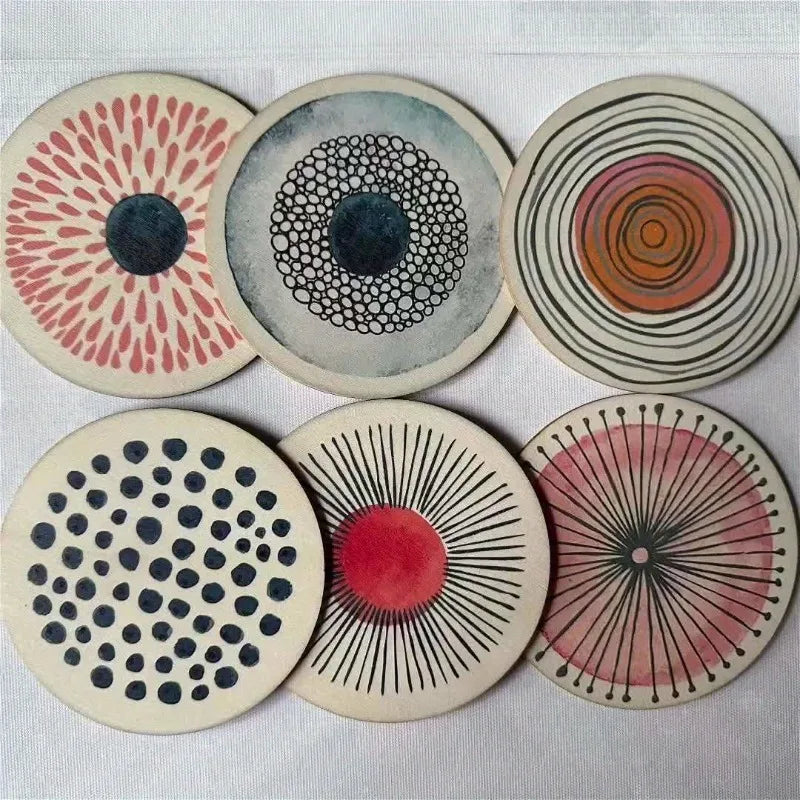 Set of six circular coasters with various patterns on a light gray background