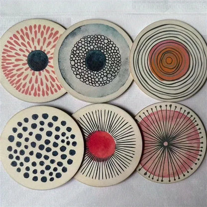 Set of six circular coasters with various patterns on a light gray background