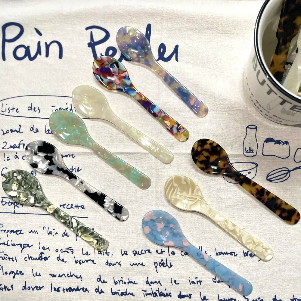 Set of decorative spoons on a piece of paper with text and a container labeled 'Butter'.