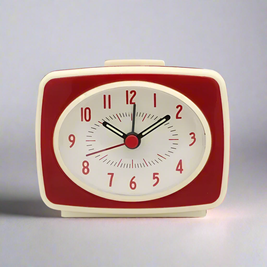Red and beige alarm clock on a white background